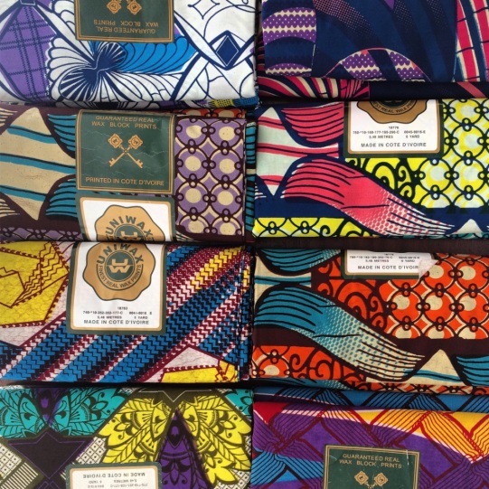 The image shows colorful wax print fabric from Burkina Faso