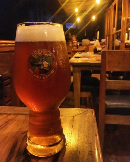 A beer sits on a table at a restaurant